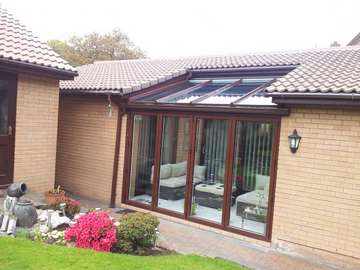 Overton , Frodsham, cheshire. Design and biuld Conservatory. Constructed from "Allstyle" Alumnium Bi folding doors, double glazed. ATS Wood foil roof glazed with celcius one self cleaning glass U value 1. 